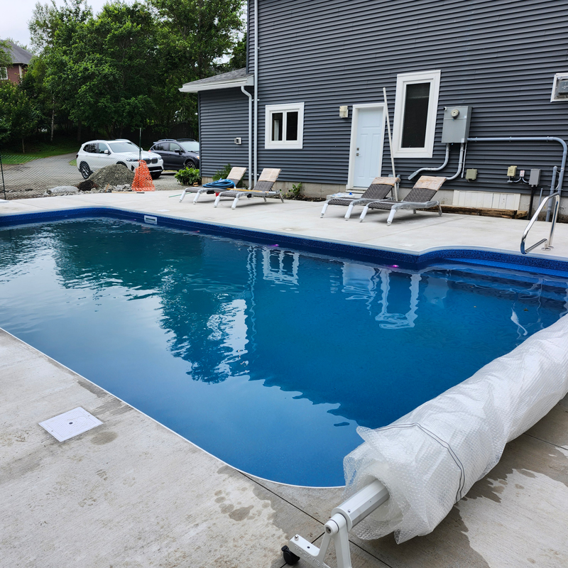 in ground swimming pool with rollable cover