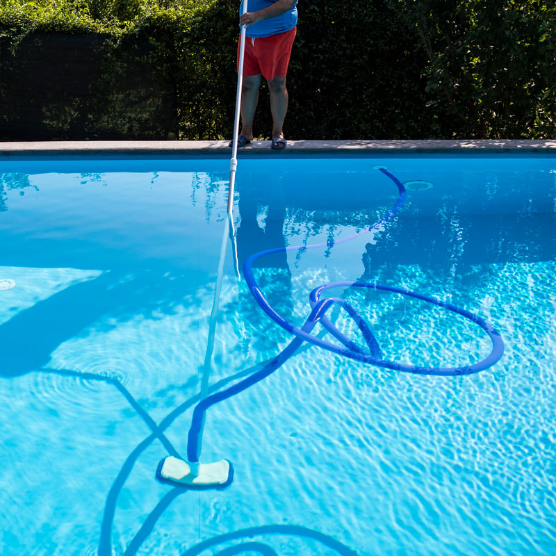 someone cleaning a pool